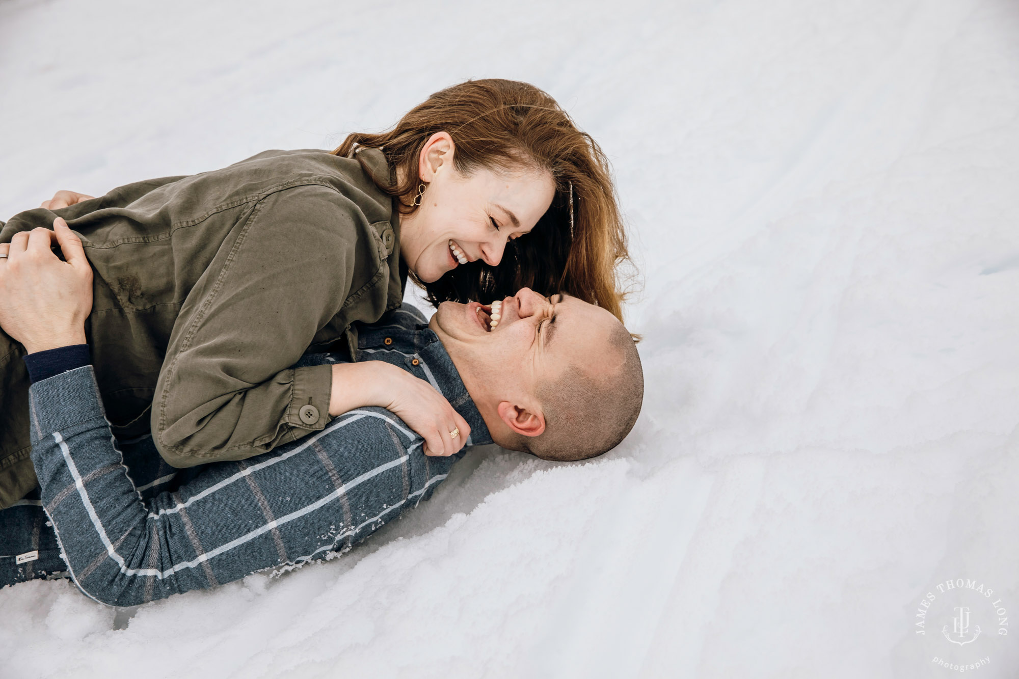 Cascade Mountain snowshoeing adventure engagement session in the snow by Snoqualmie wedding photographer James Thomas Long Photography